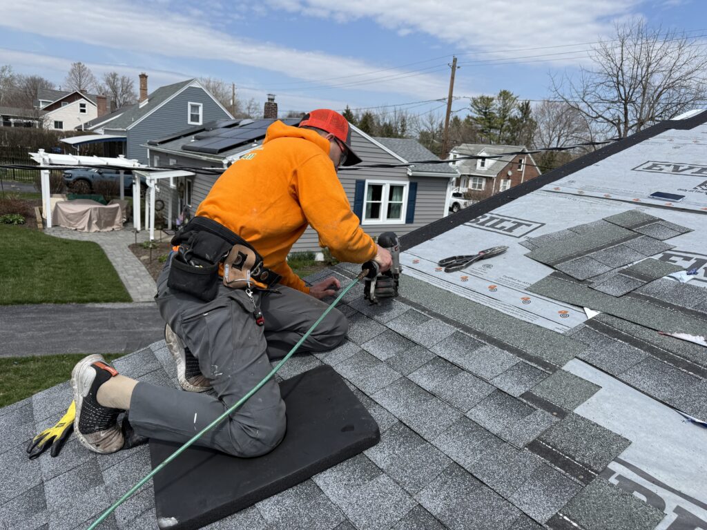 roofing contractor installing new shingles during roof replacement in bethlehem pa