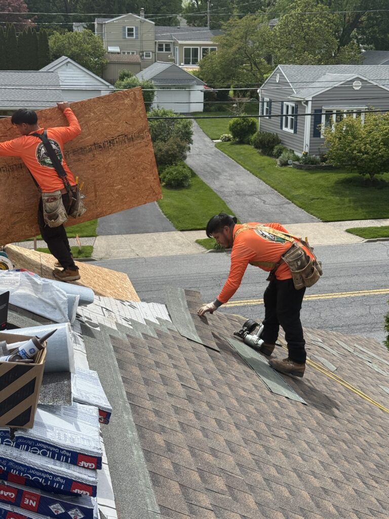 Alt Text: Roofing crew installing GAF Barkwood shingles during ranch home roof replacement in Bethlehem PA on Butztown Rd