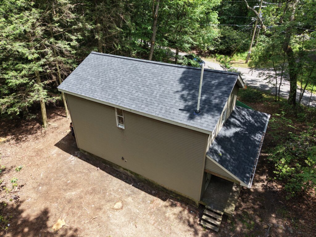 Back of house after single family roof replacement in Jim Thorpe PA on Wargo Dr — new GAF Timberline HDZ Charcoal shingles by Roofera