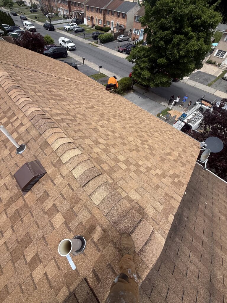 During roof installation process on townhouse in Allentown PA on E Mosser St showing new shingles being installed by Roofera
