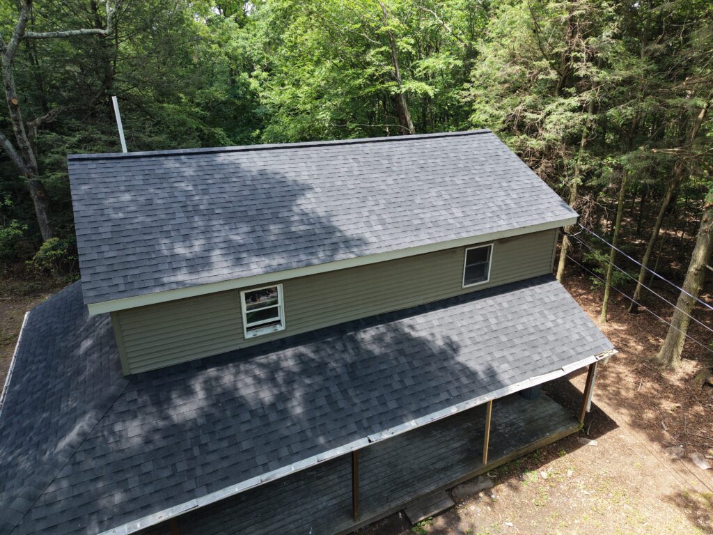 Front of house after single family roof replacement in Jim Thorpe PA on Wargo Dr — new GAF Timberline HDZ Charcoal shingles by Roofera