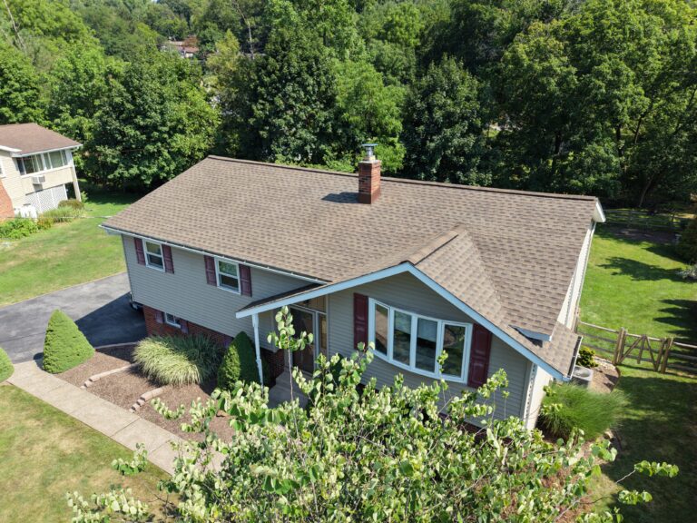 Front view of home with newly installed asphalt shingle roof after replacement