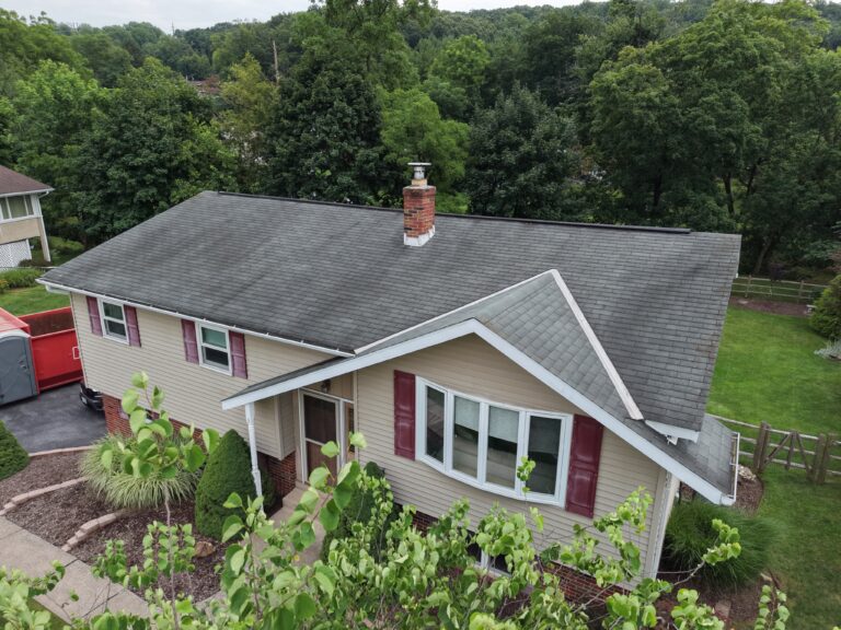 Aerial view of a worn asphalt shingle roof before replacement
